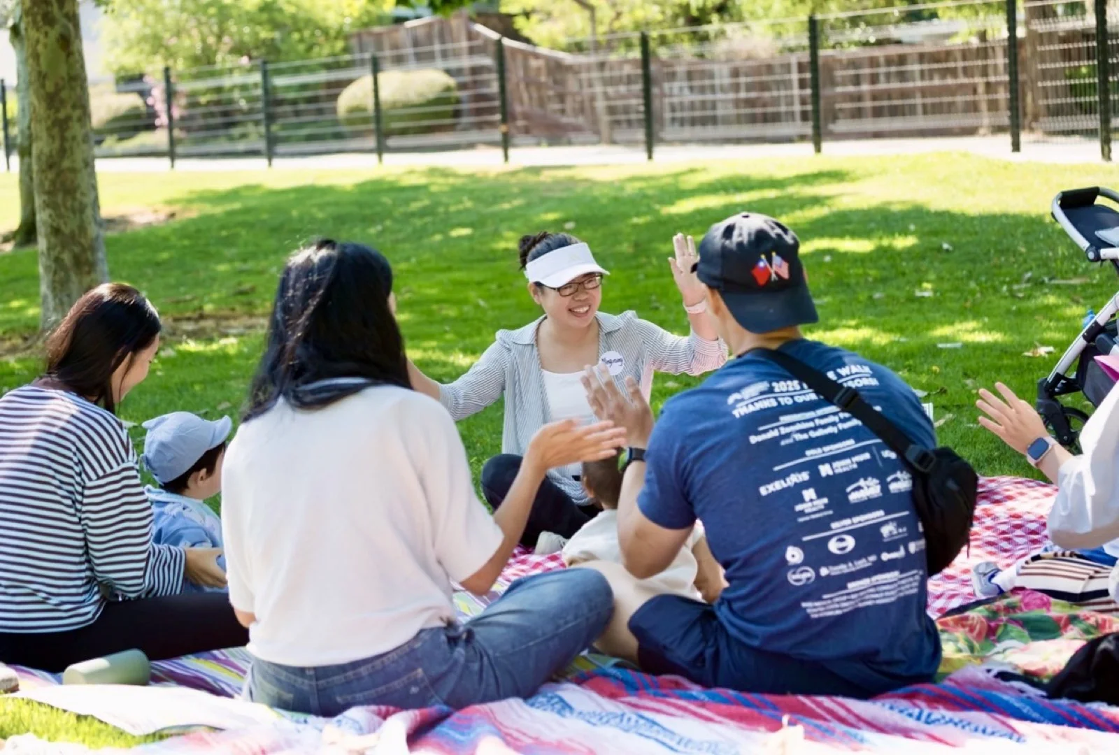 Ning leading an outdoor Mandarin Little Circle activity with children and caregivers